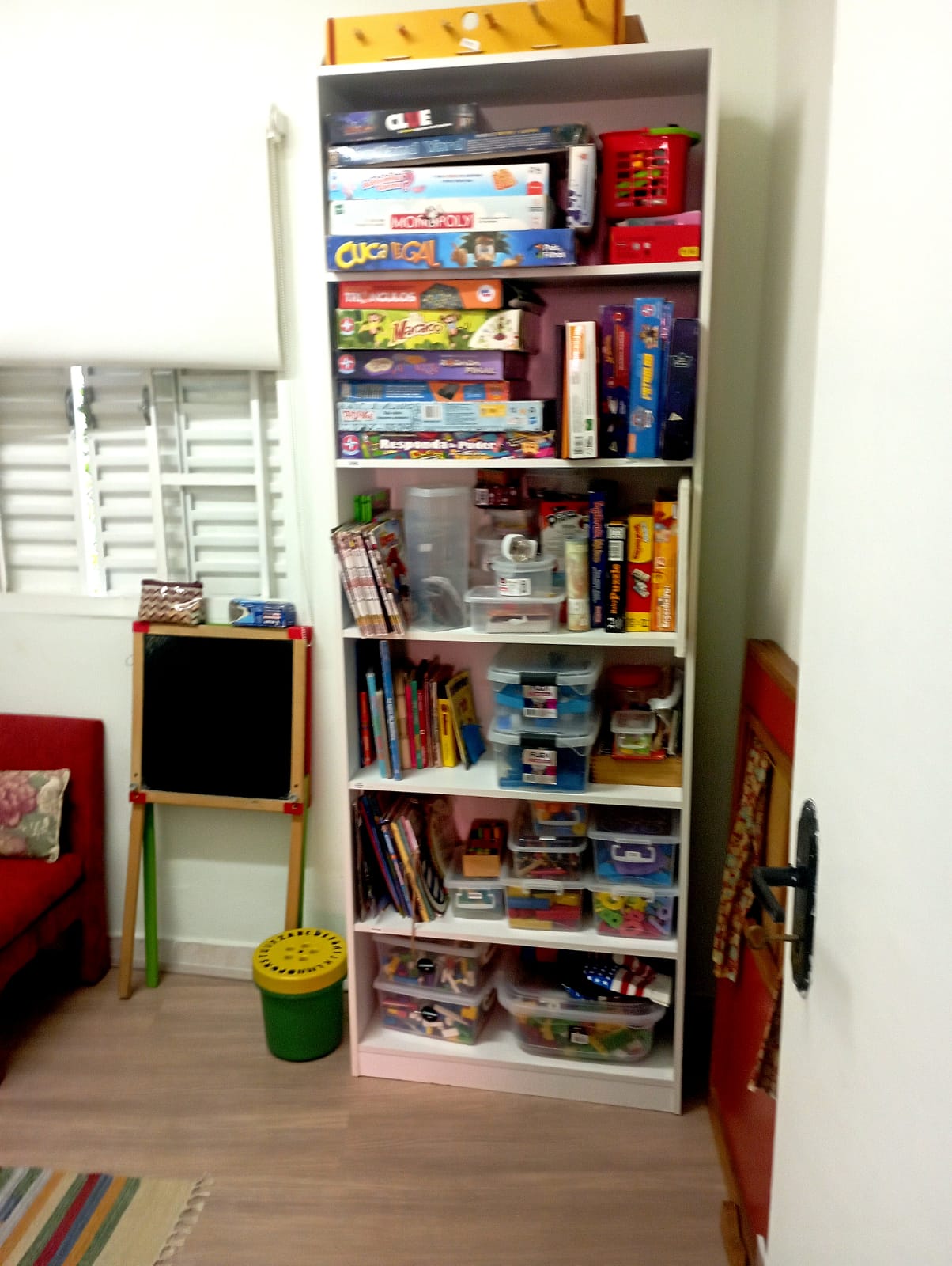 Estante organizada com jogos e materiais lúdicos